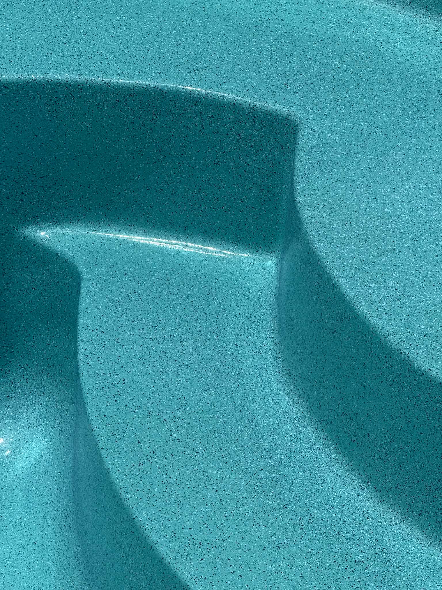 Close-up of blue speckled pool finish
