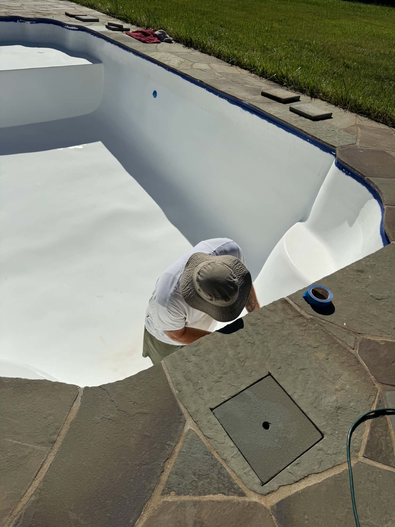 Technician working inside a drained pool