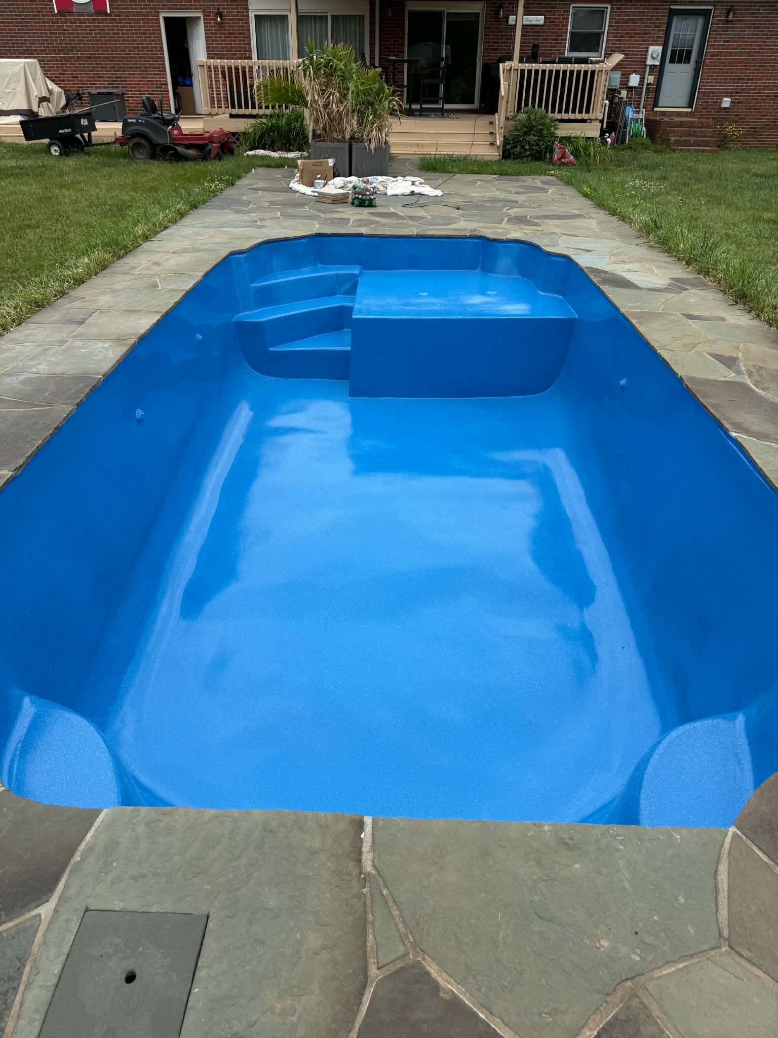 Bright royal-blue rectangular fiberglass pool after resurfacing