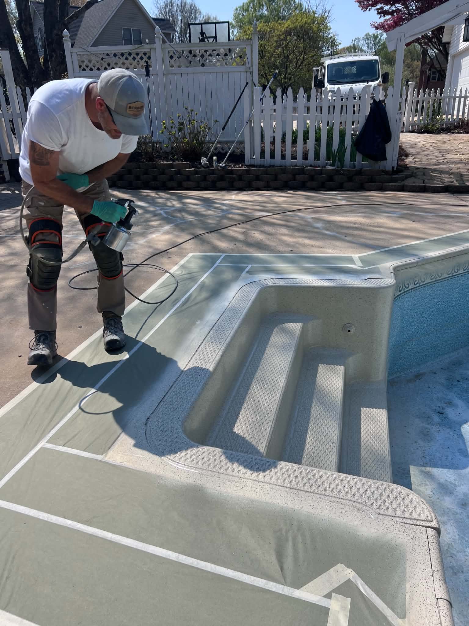 Technician spraying the pool step area
