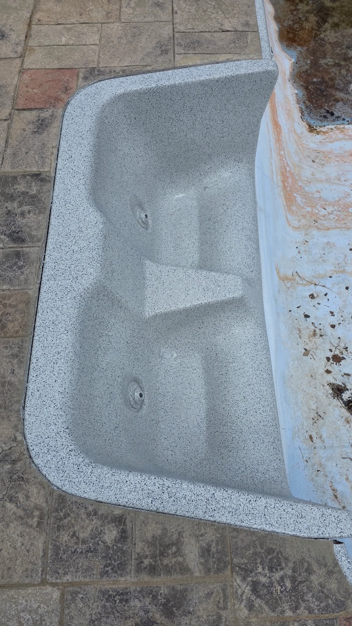 Gray-speckled fiberglass buddy seat after resurfacing