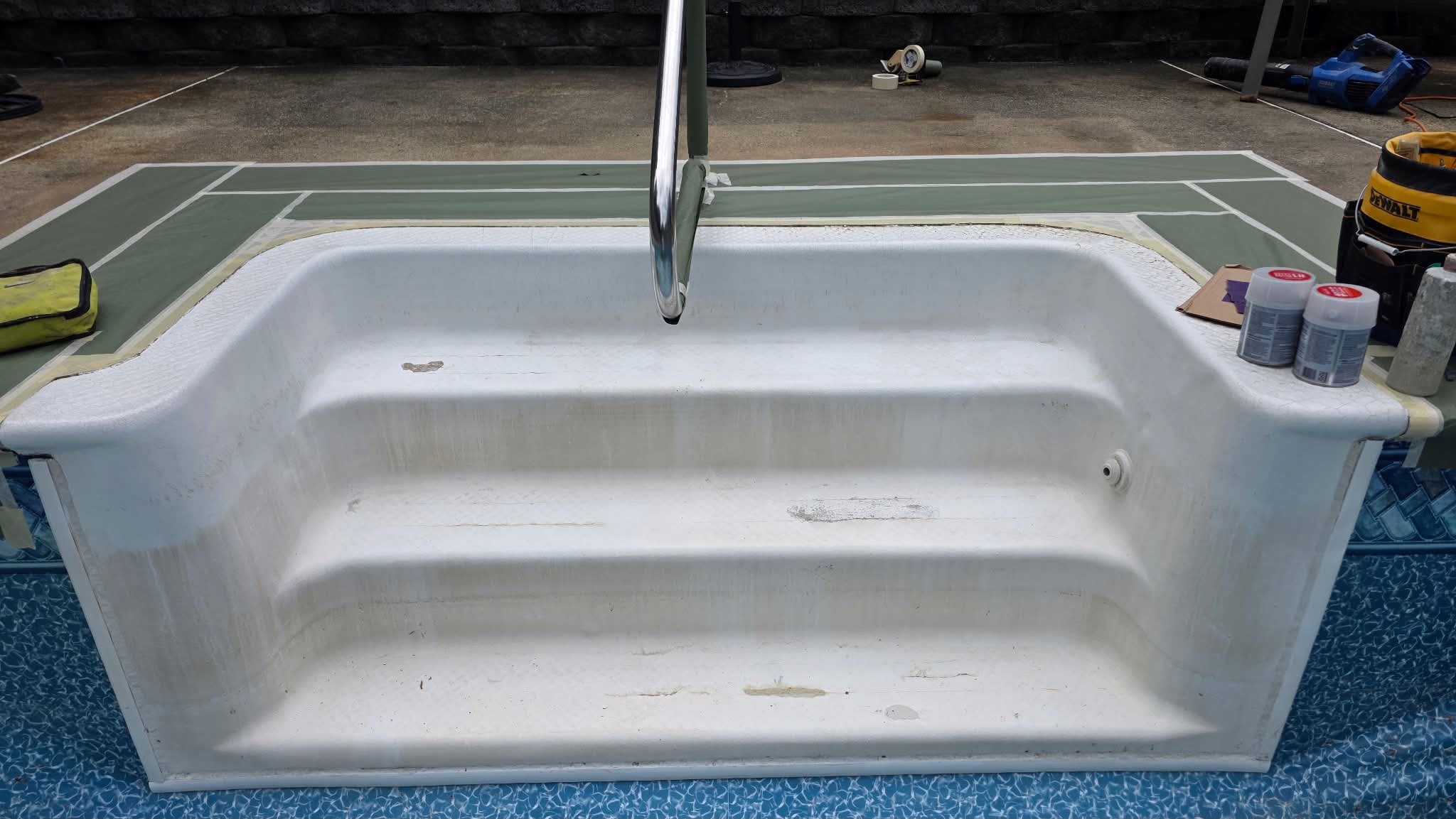 White resurfaced fiberglass pool steps