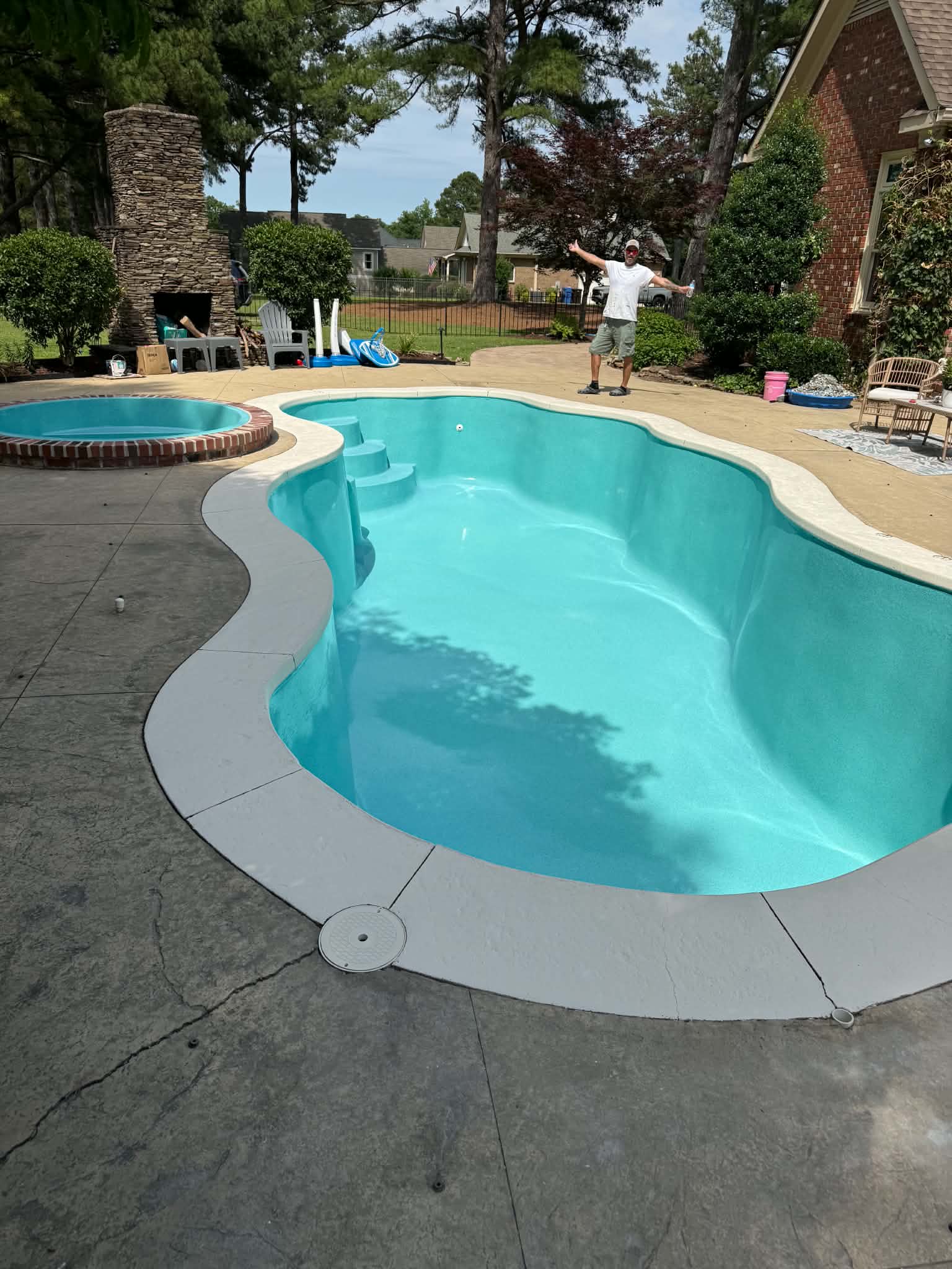 Finished turquoise swimming pool filled with water