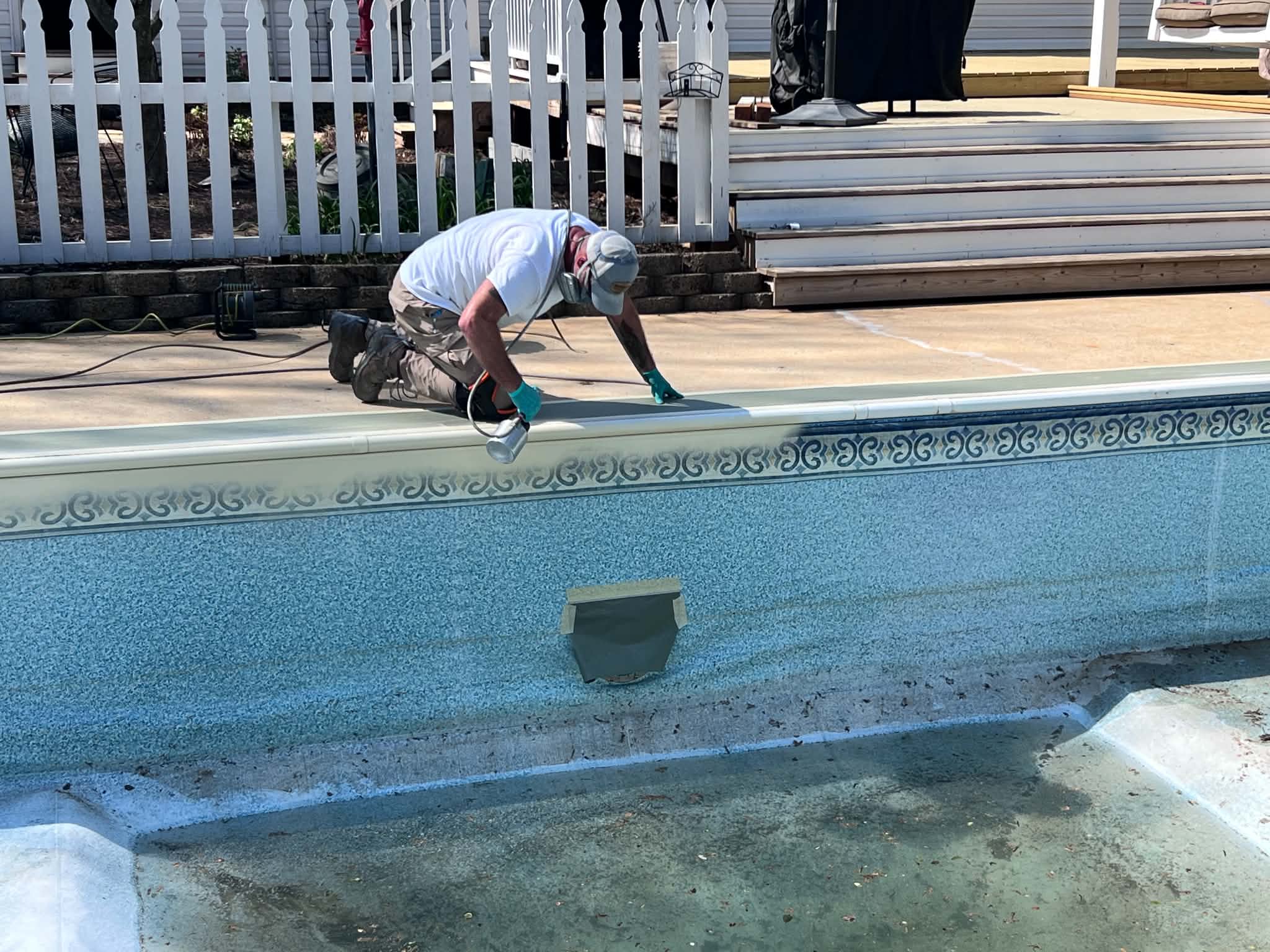 Technician repairing a fiberglass pool wall
