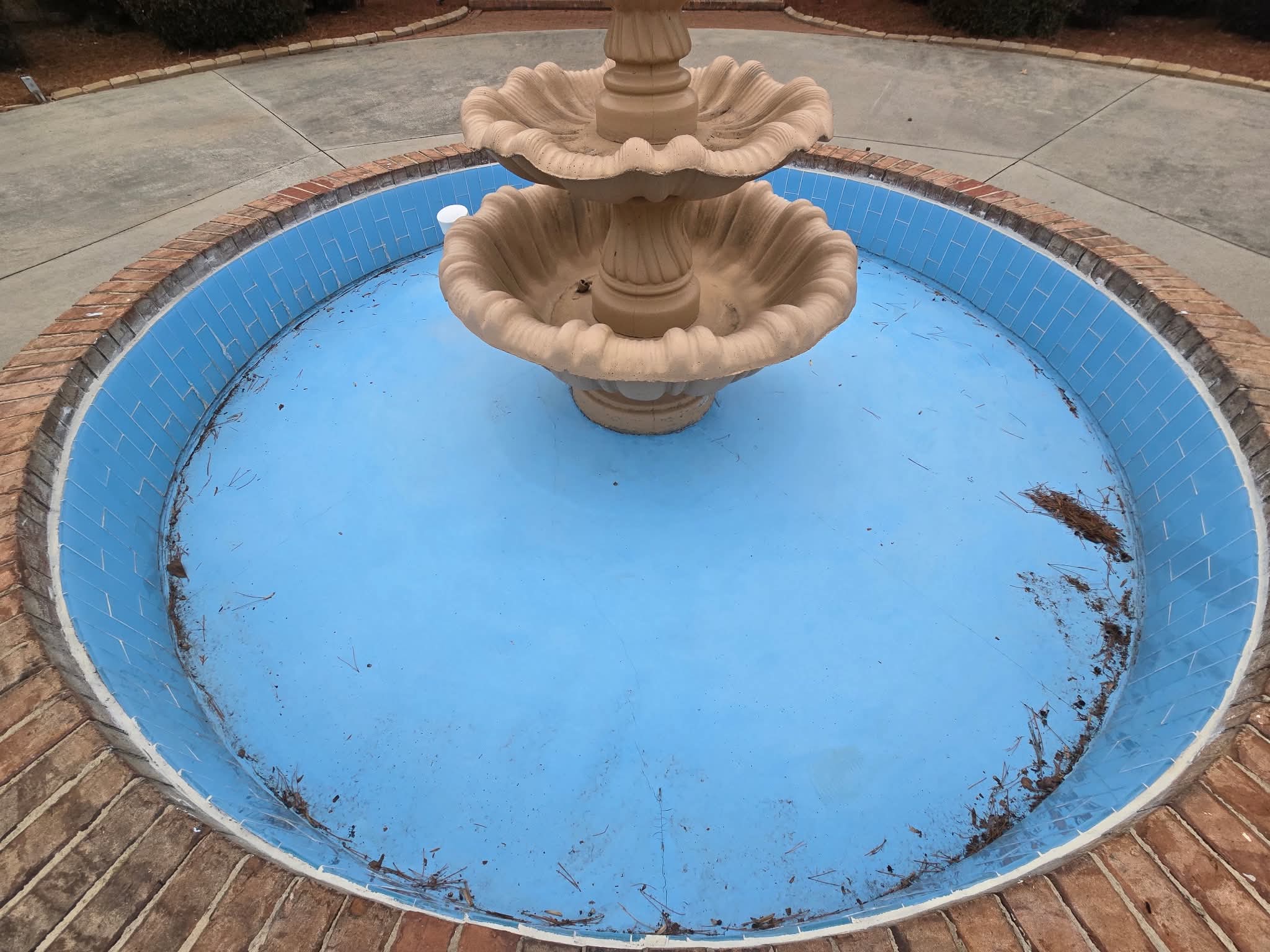 Worn blue fountain basin from above