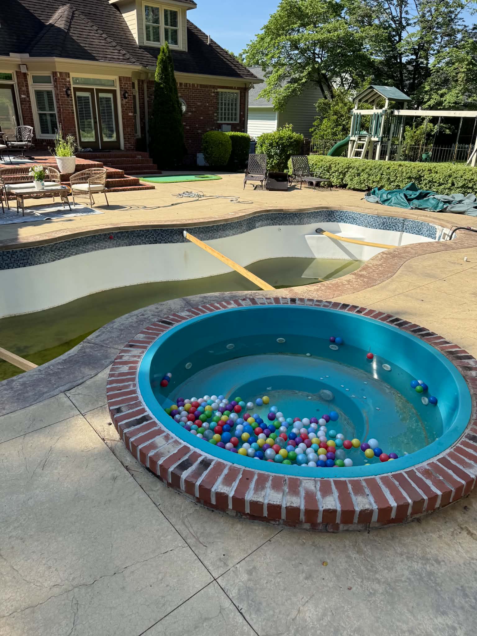 Wide courtyard view showing the pool and circular spa