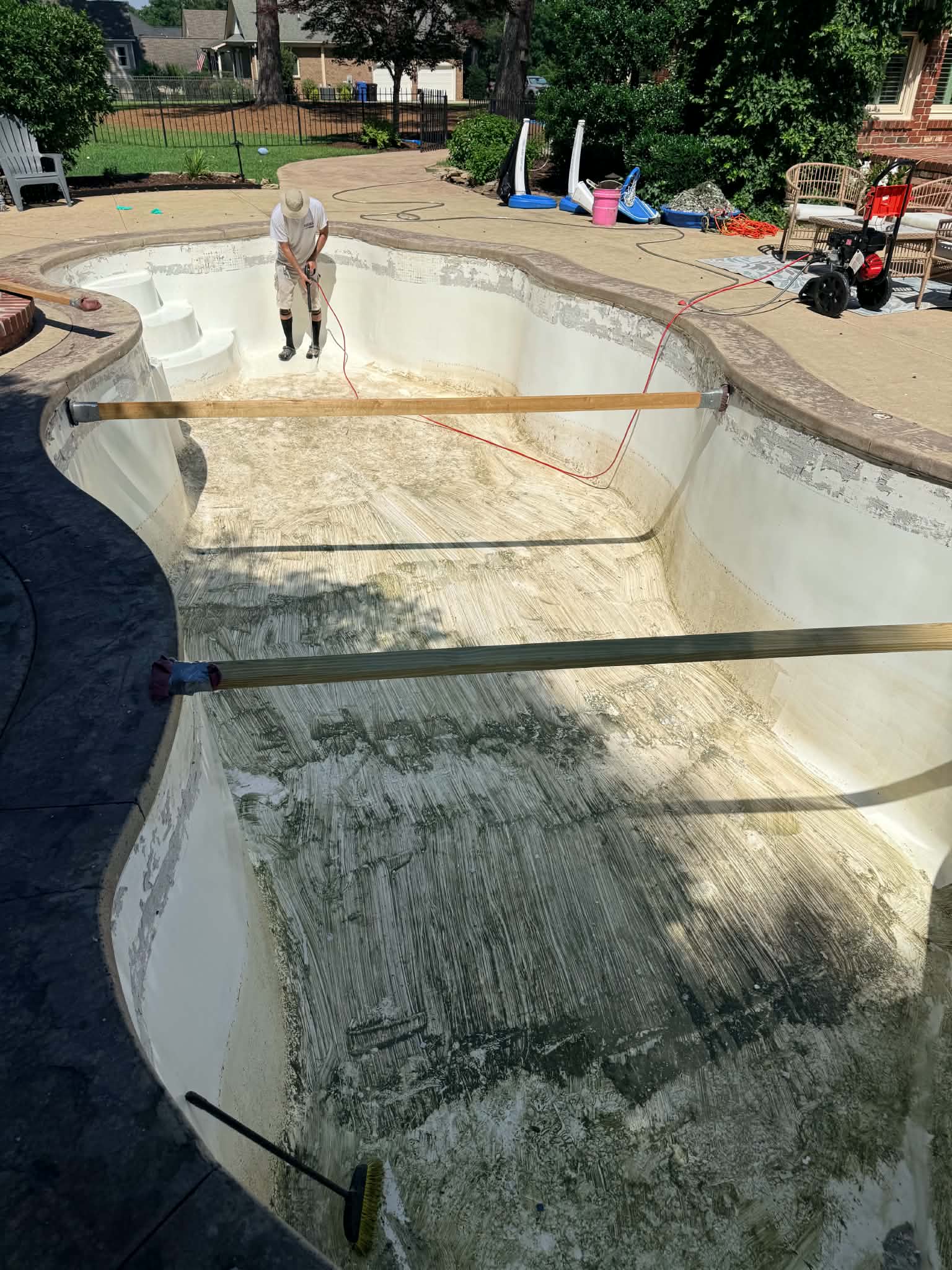 Drained courtyard pool during surface preparation