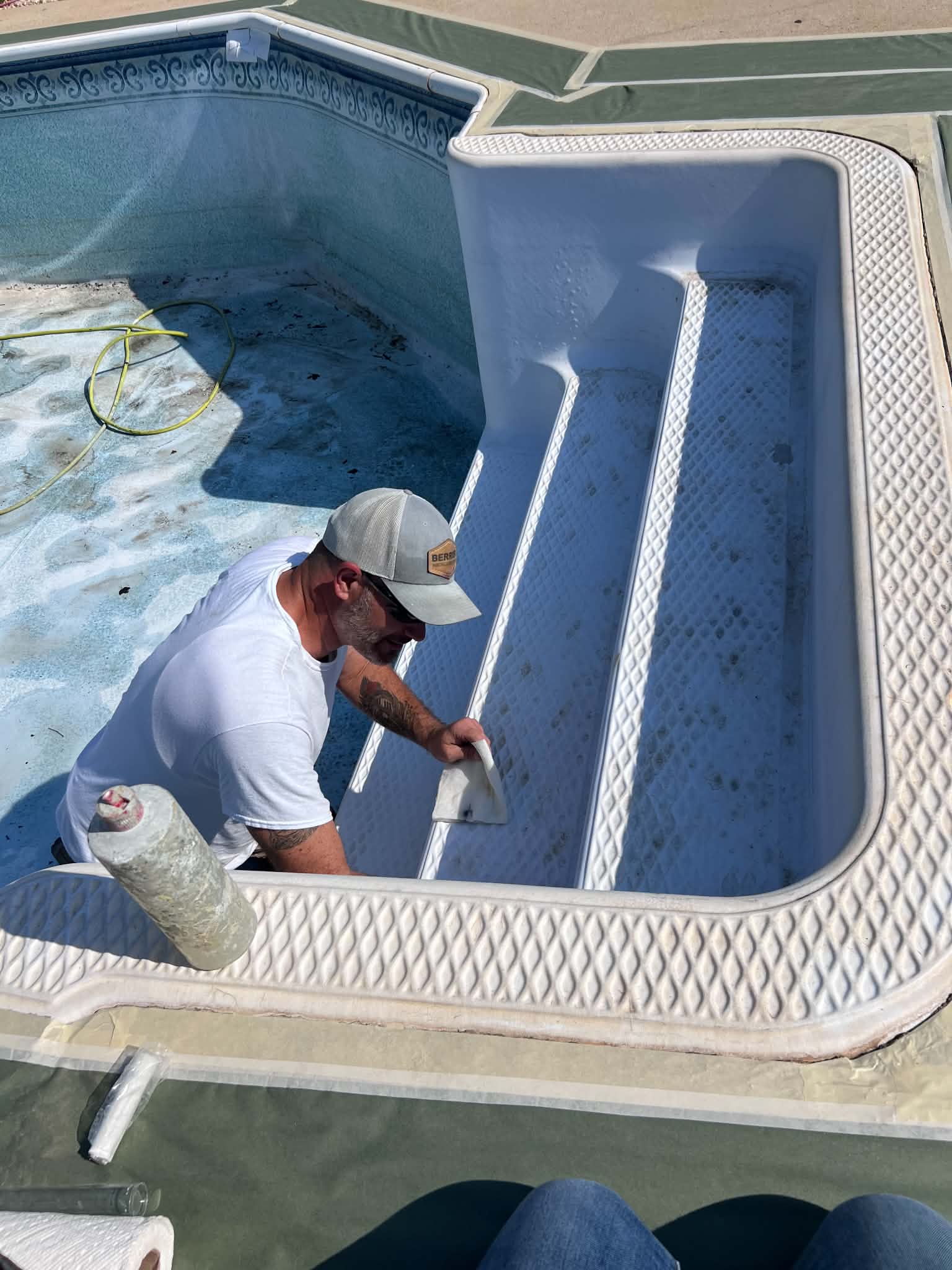 Technician coating the inside of a spa