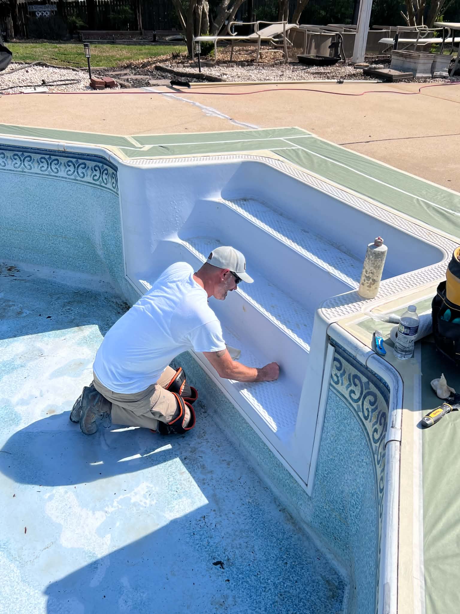 Technician spraying the interior wall of the courtyard spa