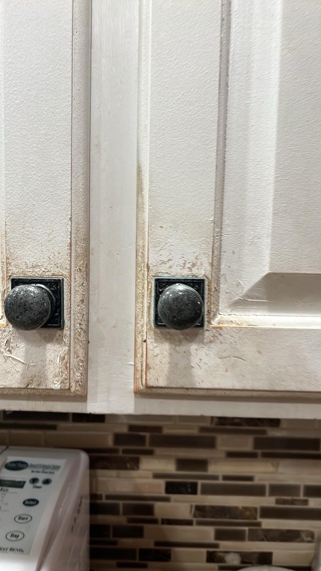 Soiled and worn white cabinet doors before refinishing