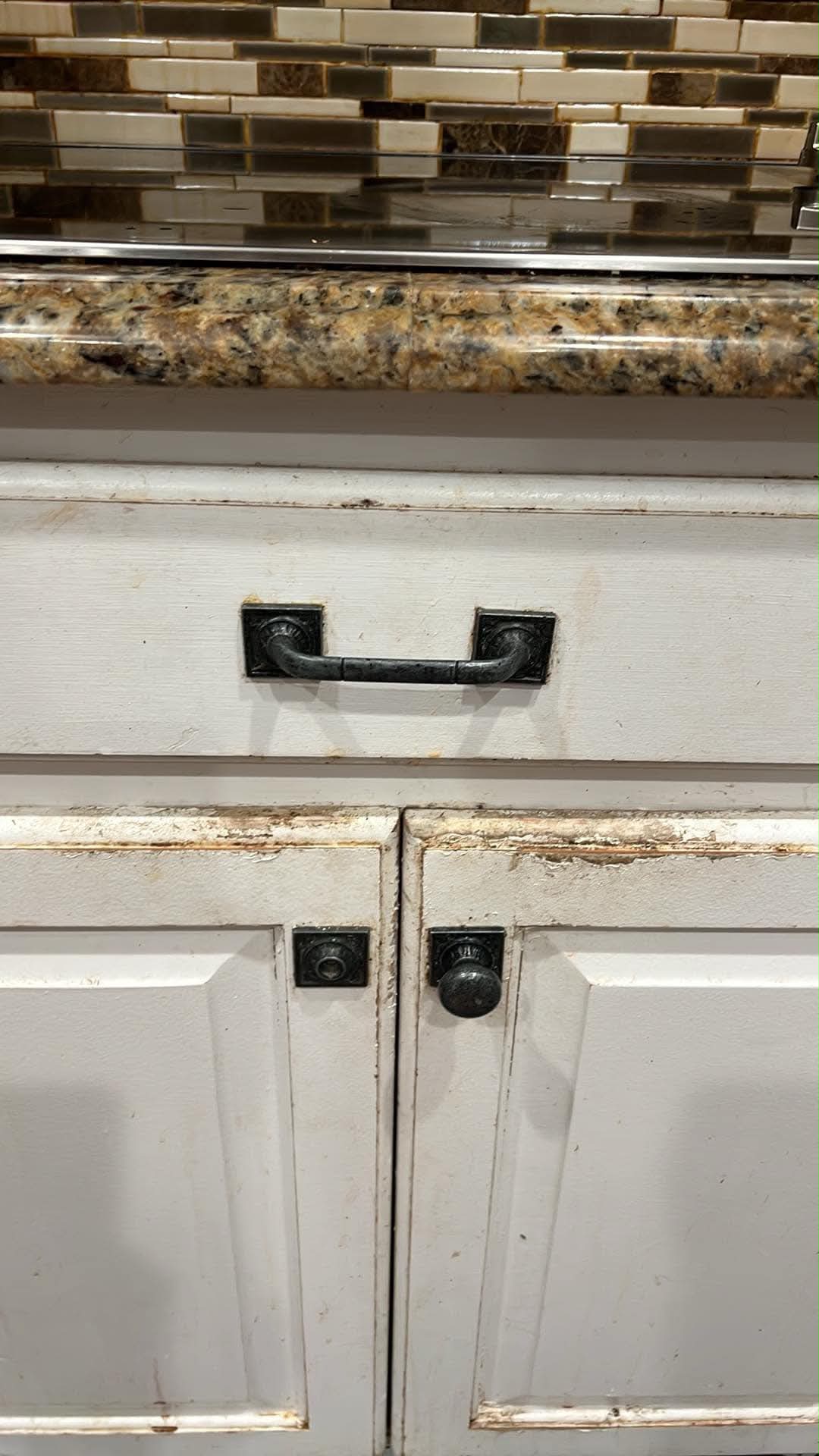 Worn cabinet doors and drawer front before refinishing