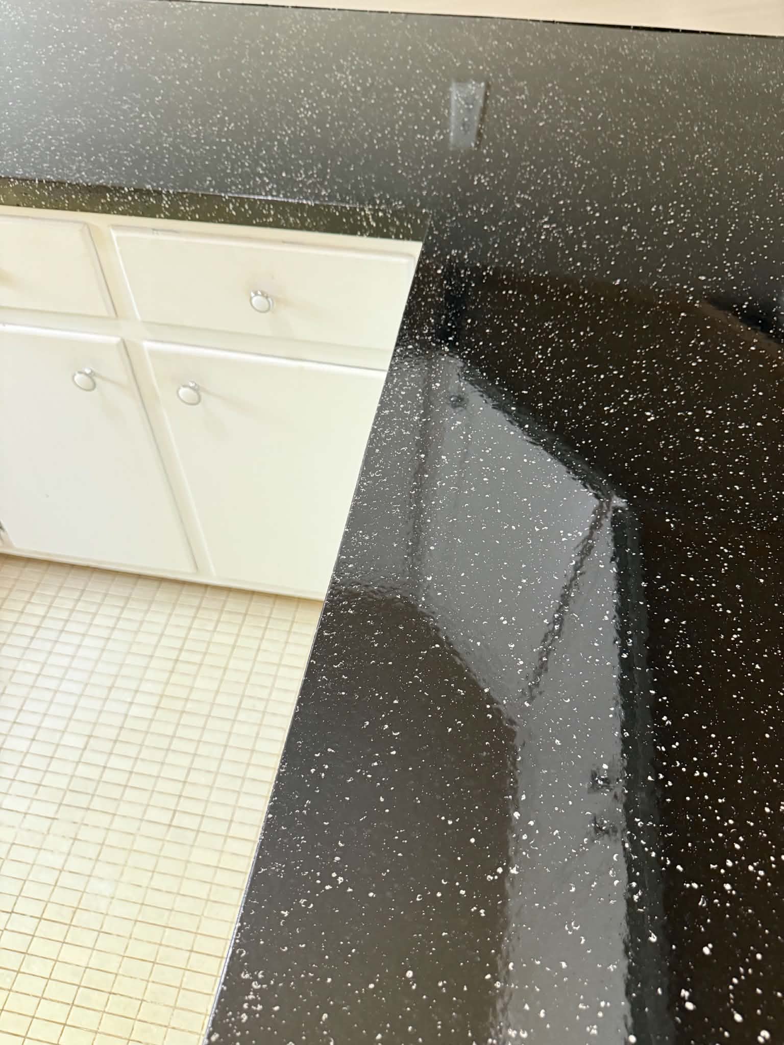 Dark speckled countertop finish at an inside corner