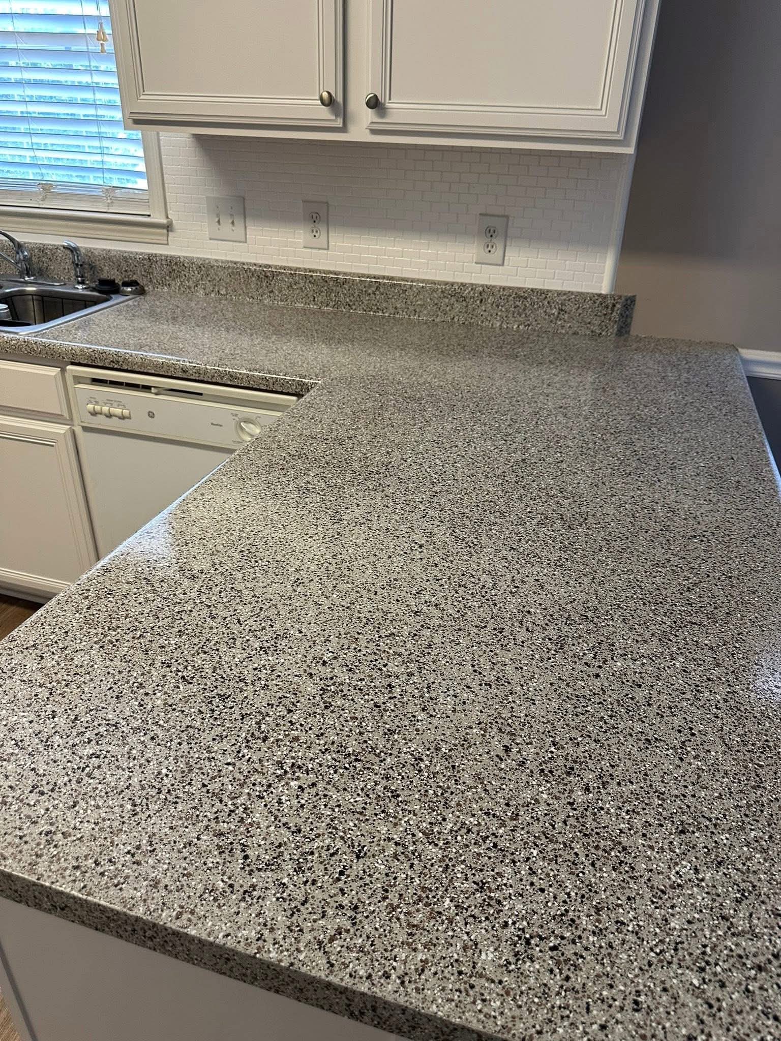 Finished gray speckled countertop across a wide counter run