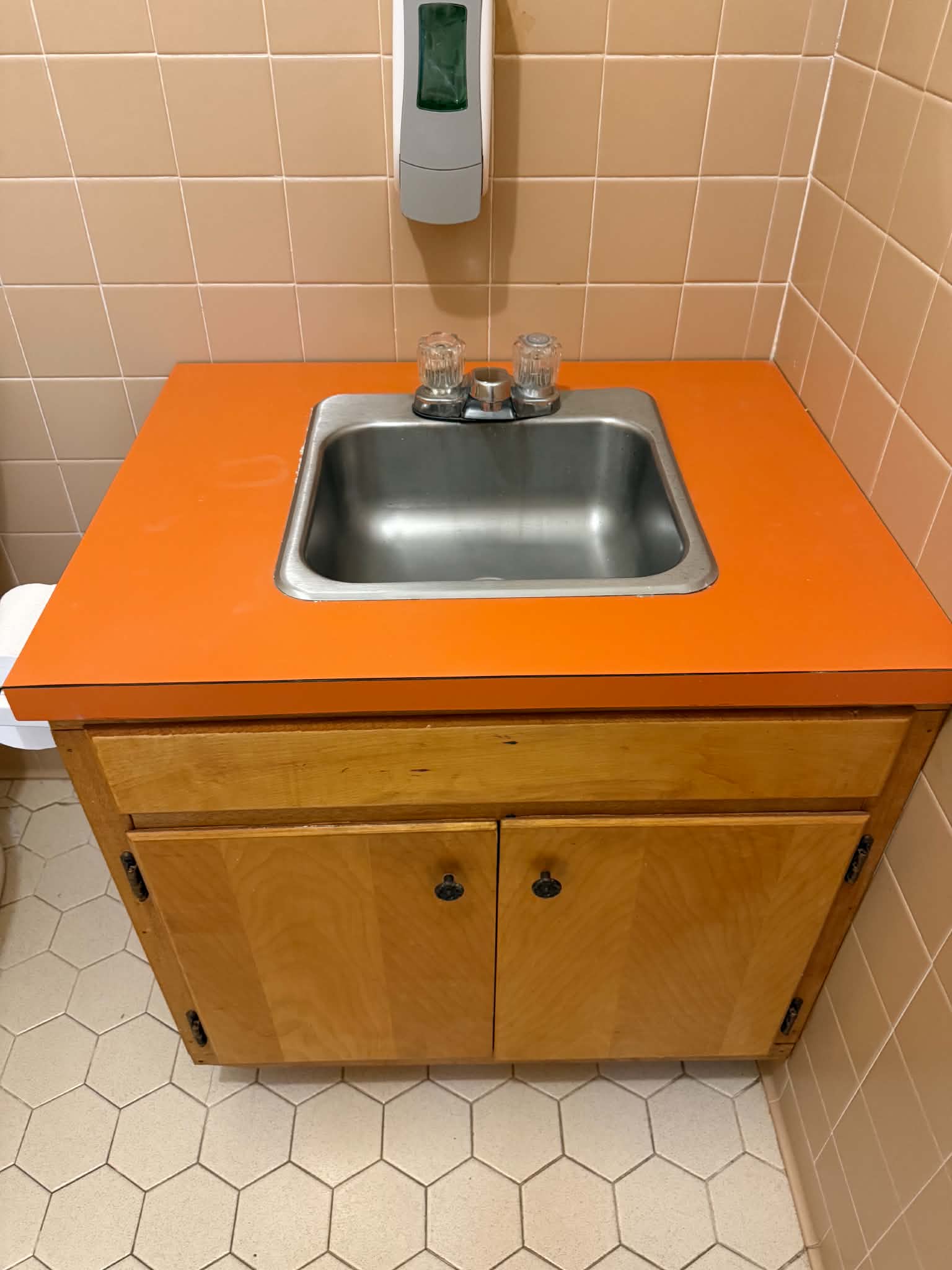 Orange bathroom vanity top before resurfacing