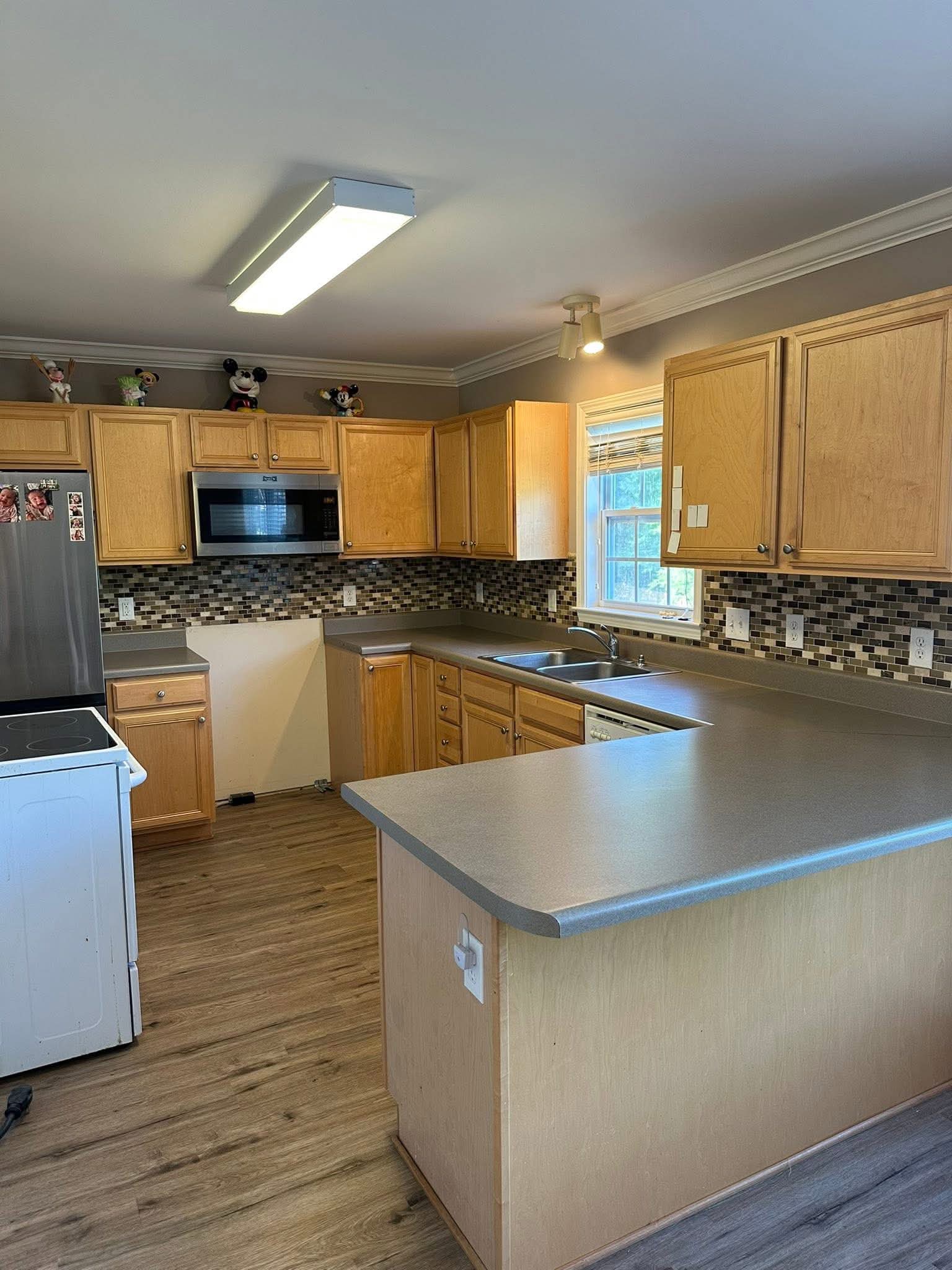 Finished gray countertop in a kitchen with natural wood cabinets