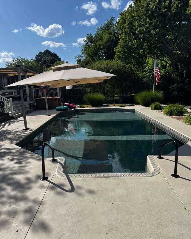 Completed rectangular swimming pool after Berrier resurfacing, viewed from the entry steps