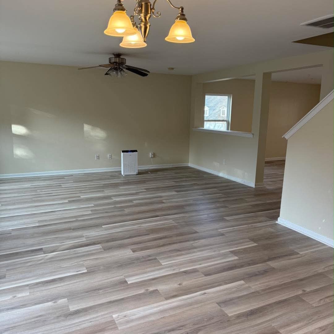 Painted living and dining area with neutral walls and white baseboards
