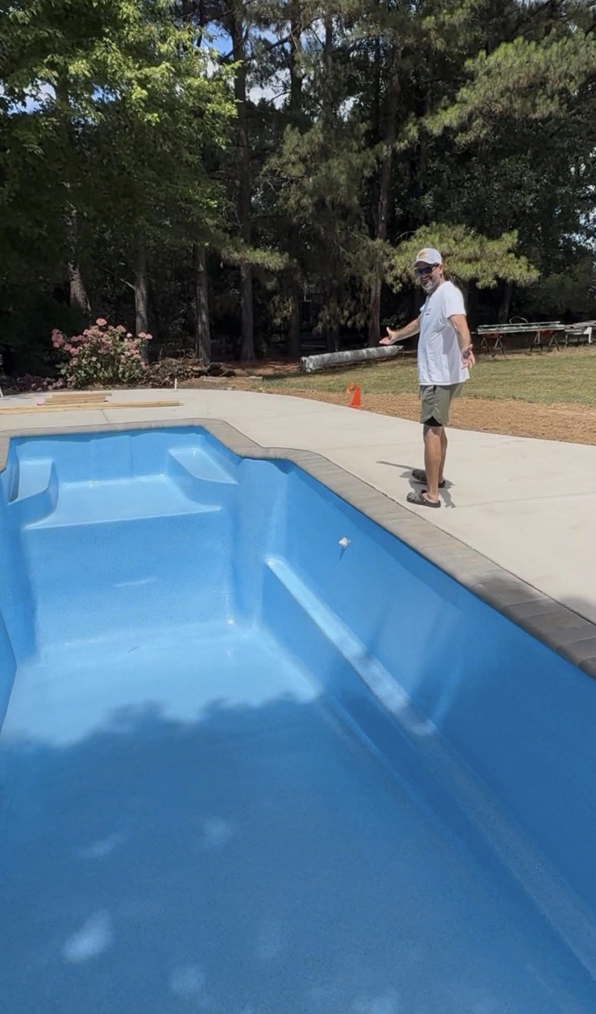 David Berrier standing beside a resurfaced blue swimming pool